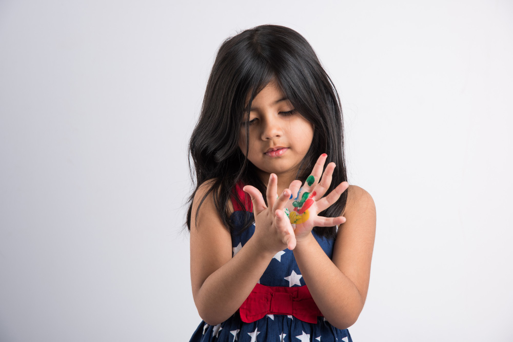 cute-little-indian-girl-showing-her-colourful-hands-or-palm-printing-or-painting-or-playing-holi-festival-with-colours-isolated-over-white-background.jpg