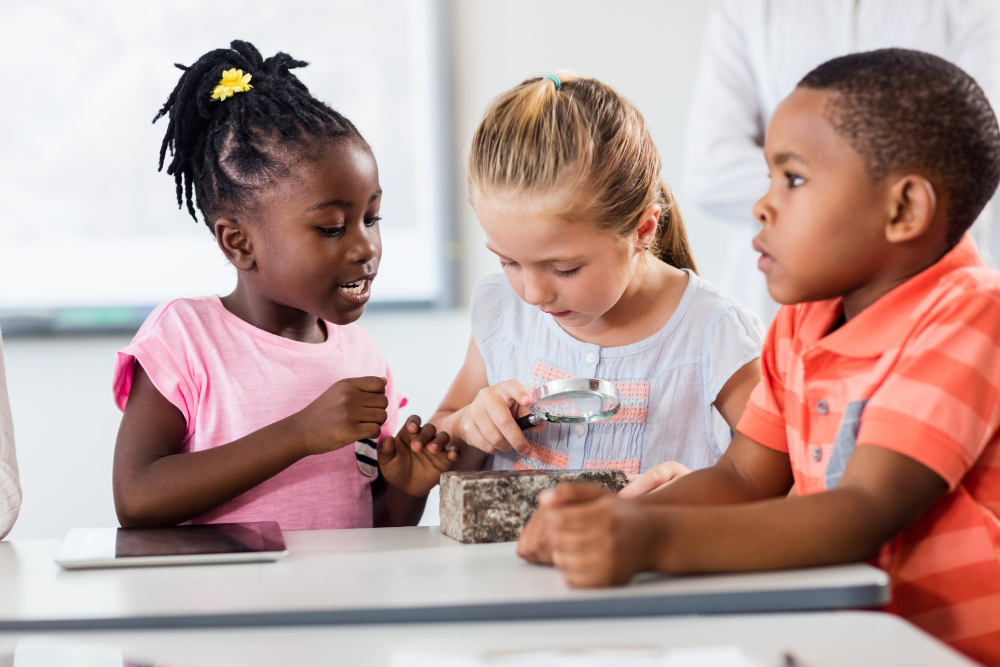 a-pupils-looking-at-rock-with-magnifying-glass.jpg