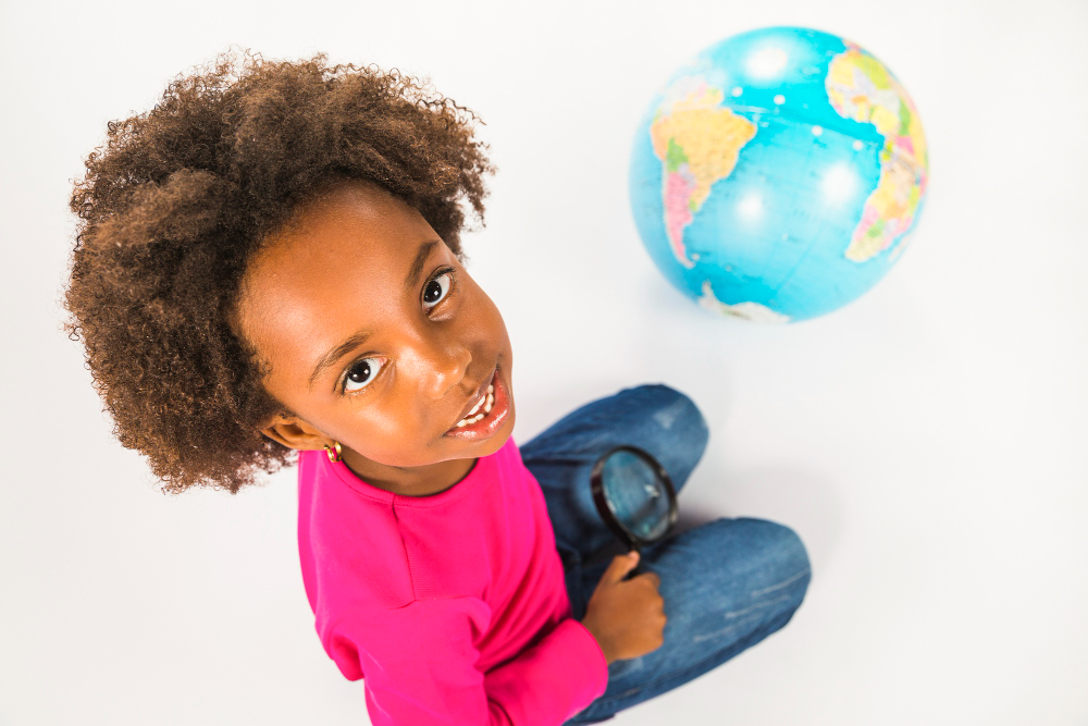 girl-with-globe-and-loupe-in-studio.jpg